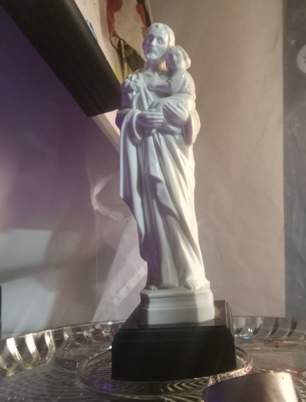 vintage religious figurine depicting Saint Joseph holding the Child Jesus,